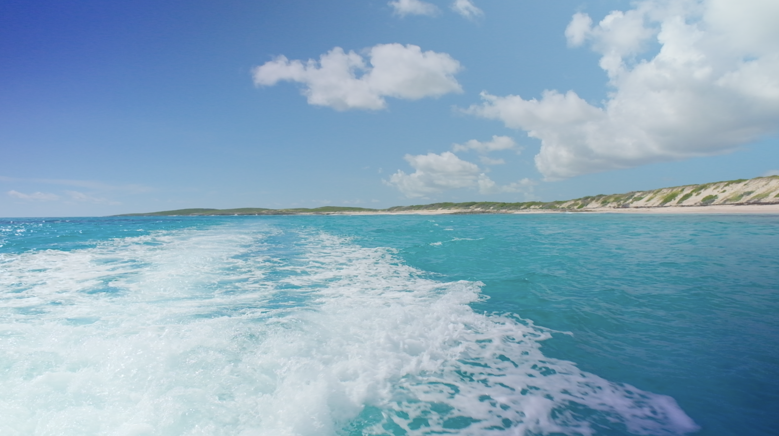 Thesea surrounding East Caicos with the beach in the background.
