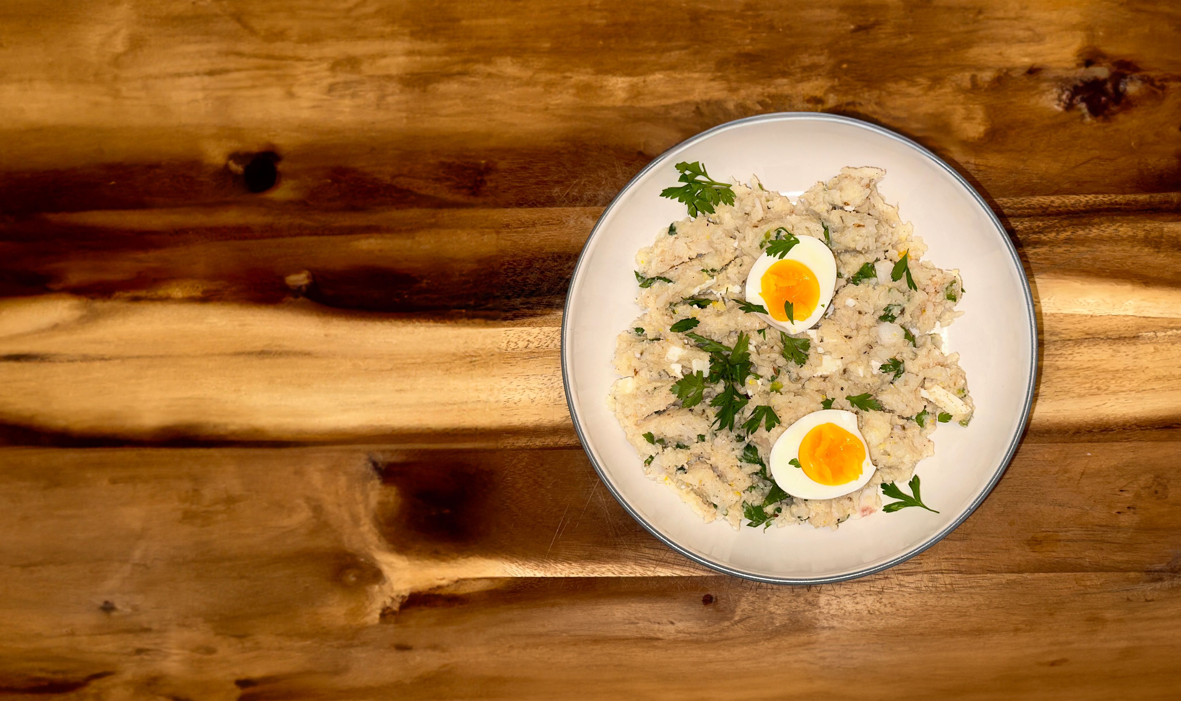Plate of kedgeree garnished with boiled eggs and parsley